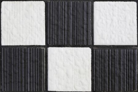 Black and white texture design similar to chess board on interior wall.