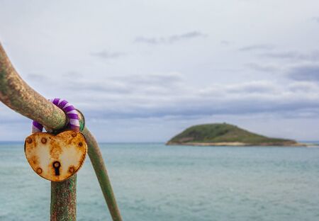 Rusty Heart Shaped Padlock. Island of Magaluf beach on a winter day