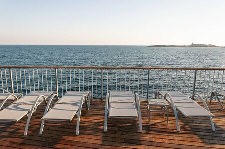 Empty hammocks in front of the Mediterranean Sea. Image of the cessation of the hotel and catering...
