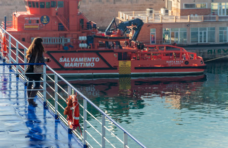 Palma de Mallorca, Balearic Islands/Spain; 01/14/2015: girl leaning over the deck railing of a ferry docked in the port of Palma de Mallorcaのeditorial素材