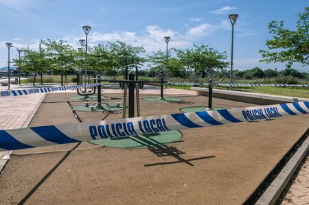 Public park sealed by a police cordon, on a sunny day, due to the quarantine for the Coronavirus...