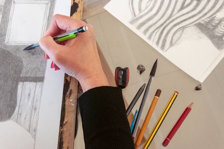 Artist drawing a pencil illustration. Creative environmentの写真素材