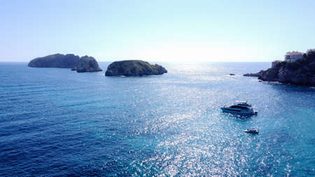 Aerial view of the Malgrats Islands from the Island of Mallorca with waves from the Mediterranean Sea and yachts at sea. Balearic Islands, Spainの写真素材
