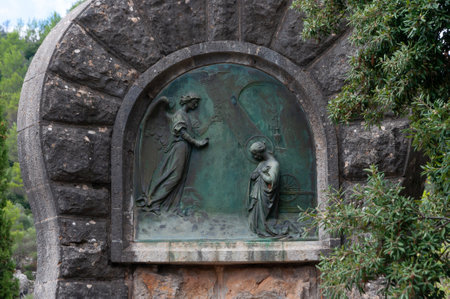 Lluc, Balearic Islands / Spain; September 2020: religious sculpture relief made in bronze on the Annunciation of the Virgin Mary. Sculpture located in the Christian Monastery of Lluc, Mallorca islandのeditorial素材