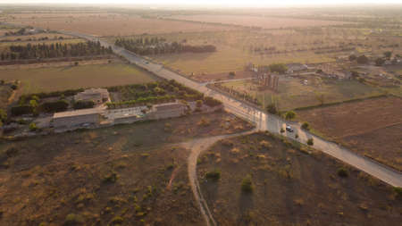 Aerial view of a rural road with vehicles circulating on a sunny afternoon. Island of Mallorca, Spainの写真素材