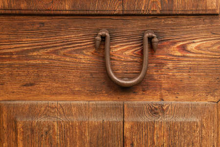 Close-up of an antique iron knob on an antique wooden door. Mallorca island, Spainの写真素材