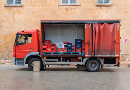 Llucmajor, Spain; December 17 2020: red beverage delivery truck parked. Inside the truck, boxes of soft drinks to be distributed to restaurantsのeditorial素材