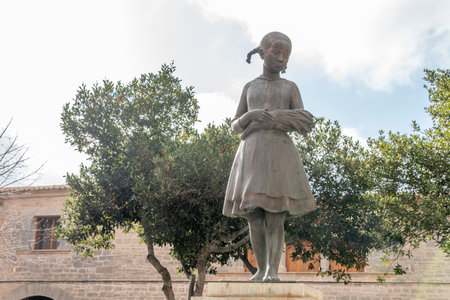 Llucmajor, Spain; December 17 2020: public bronze sculpture called Espigolera representing a girl with spikes in her handsのeditorial素材