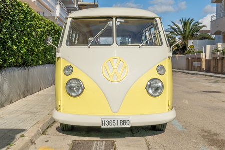 Colonia de Sant Jordi, Spain; February 13 2021: Yellow and white Wolkswagen T1 van parked in a sunny street in the Majorcan town of Colonia de Sant Jordiのeditorial素材
