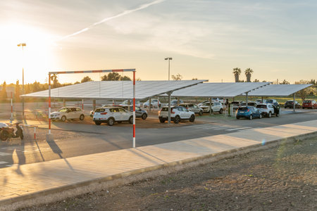 Campos, Spain; February 16 2021: parking lot of the sports complex in the town of Campos at sunset, with solar panels that generate ecological electricityのeditorial素材
