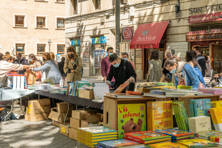Palma de Mallorca; April 23 2021: Festivity of Sant Jordi or Book Day in the historic center of Palma de Mallorca in times of the Coronavirus pandemic. Facial mask and social distance. New normalのeditorial素材