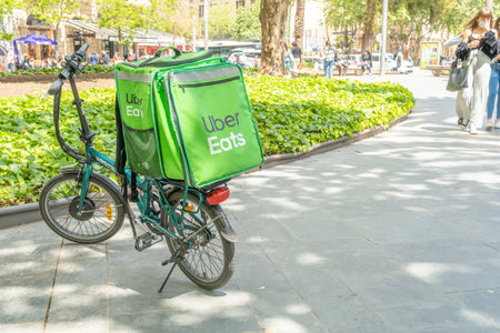 Palma de Mallorca, Spain; April 23 2021: Parked green bicycle of the Uber Eats company at Plaza de...