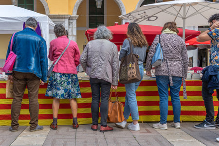 Palma de Mallorca; April 23 2021: Festivity of Sant Jordi or Book Day in the historic center of Palma de Mallorca in times of the Coronavirus pandemic. Facial mask and social distance. New normalのeditorial素材
