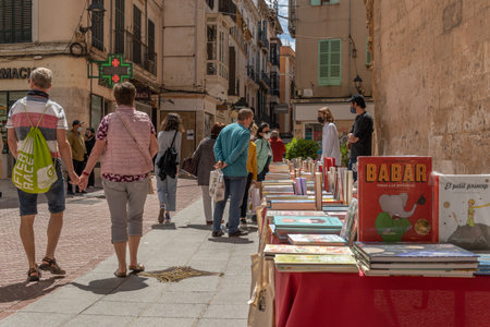 Palma de Mallorca; April 23 2021: Festivity of Sant Jordi or Book Day in the historic center of Palma de Mallorca in times of the Coronavirus pandemic. Facial mask and social distance. New normalのeditorial素材