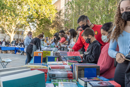 Palma de Mallorca; April 23 2021: Festivity of Sant Jordi or Book Day in the historic center of Palma de Mallorca in times of the Coronavirus pandemic. Facial mask and social distance. New normalのeditorial素材
