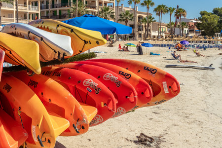 Colonia de Sant Jordi, Spain; July 02 2021: Close-up of some canoes piled up on the beach of the Colonia de Sant Jordi. Summer activities for children during the summer school vacationsのeditorial素材