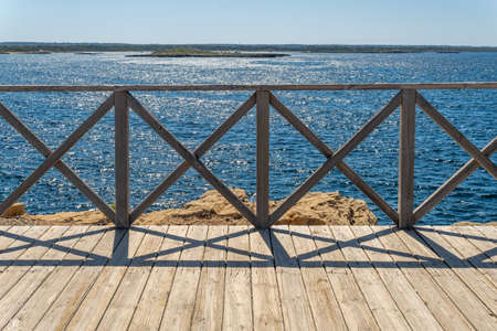 Wooden footbridge on the Mediterranean coast of the island of Majorca in summertime