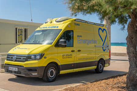 Platja de Palma, Spain; July 16 2021: Yellow ambulance parked on the promenade of the beach of Palma de Mallorca to attend medical emergencies on the beachのeditorial素材