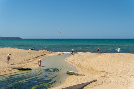 Platja de Palma, Spain; July 16 2021: General view of the beach of Palma de Mallorca on a sunny summer day, with tourists on its beaches after the Covid-19 pandemicのeditorial素材