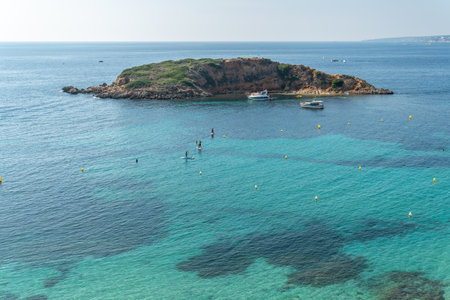 Portals Nous, Spain; October 02 2021: Aerial view of the beach of the Mallorcan town of Portals Nous and the island of Sales on a sunny morning with bathers on the beachのeditorial素材