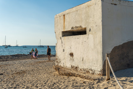 Es Trenc, Spain; October 11 2021: Old bunker of the Spanish civil war on the beach of Es Trenc, next to bathers, at sunset. Island of Mallorca, Spainのeditorial素材