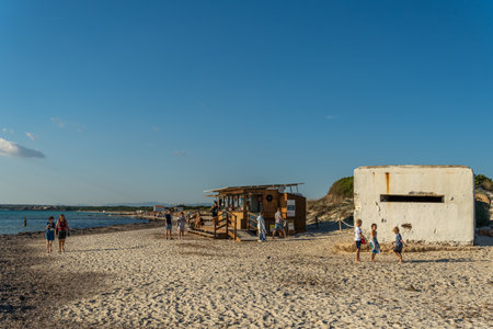 Es Trenc, Spain; October 11 2021: Old bunker of the Spanish civil war on the beach of Es Trenc, next to bathers, at sunset. Island of Mallorca, Spainのeditorial素材