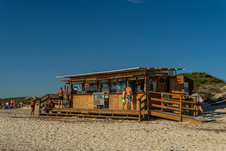 Es Trenc, Spain; October 11 2021: General view of a beach bar at sunset, with tourists in the establishment. Es Trenc beach, island of Mallorca, Spainのeditorial素材