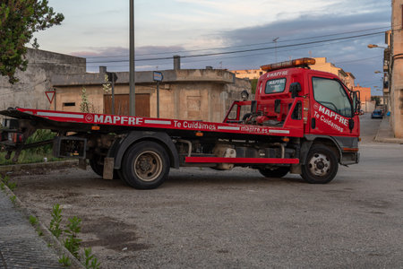 Campos, Spain; October 19 2021: Red tow truck of the insurance company Mapfre, parked in the Majorcan town of Campos, at dawnのeditorial素材