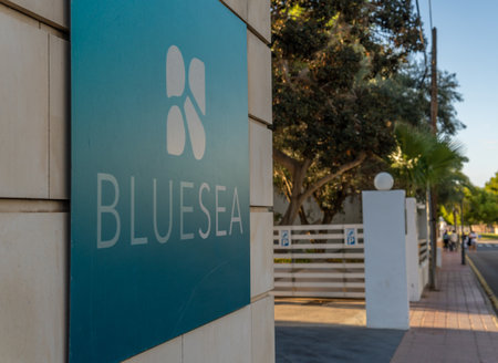 Cala D'Or, Spain; October 23 2021: Close-up of the Bluesea hotel company's sign at sunset in the Mallorcan town of Cala d'Orのeditorial素材