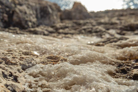 Close-up of salt crystals on the coastal rocks of the Mediterranean Sea, product of the evaporation of sea waterの写真素材