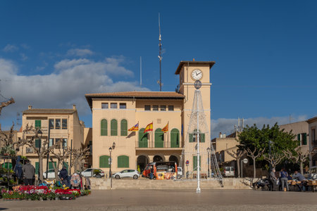 Ses Salines, Spain; december 09 2021: General view of the Town Hall square in the Mallorcan town of Ses Salines, on a Christmas morning, with the typical street market with customers and vendorsのeditorial素材