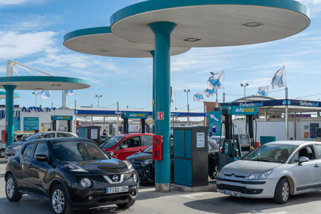 Palma de Mallorca, Spain; December 27 2021: Autonetoil gas station with customers, located in an...
