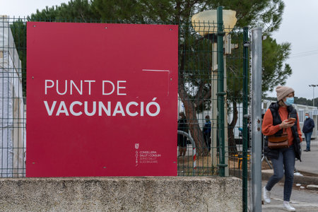 Palma de Mallorca, Spain; January 02 2022: Covid-19 vaccination point at the antique Son Dureta hospital in Palma de Mallorca. People with mask queuing for vaccination. New normality conceptのeditorial素材