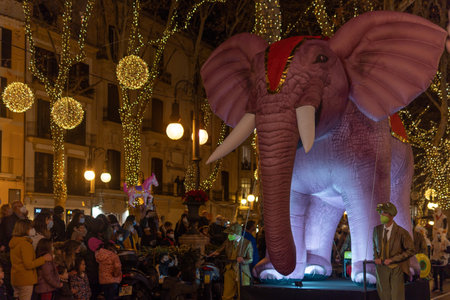 Palma de Mallorca, Spain; January 06 2022: Cavalcade of the Three Wise Men of the East, at Christmas time. Participants and public wearing face masks due to restrictions of the Coronavirus pandemicのeditorial素材