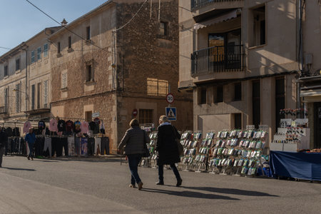 Campos, Spain; january 15 2022: Weekly street market in the Majorcan town of Campos. Vendors and customers with masks due to restrictions by the Omicron variant of Coronavirus. new-normalのeditorial素材