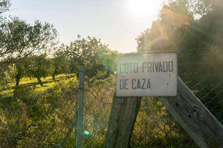 Private hunting preserve sign, written in Spanish, in a rural field on the island of Mallorca, Spainの写真素材