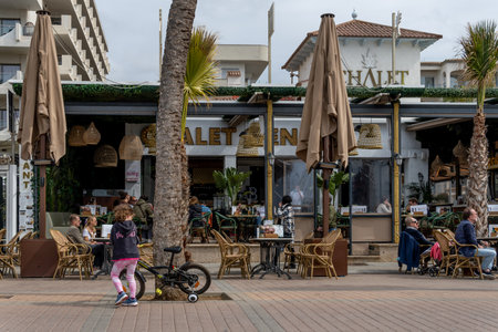 Palma Beach, Spain; march 13 2022: Cafeteria terrace on the promenade of Playa de Palma, a cloudy winter morning. Island of Majorca, Spainのeditorial素材