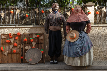 Porreres, Spain; June 04 2022: Annual apricot fair held in the Majorcan town of Porreres, Spain. Street decoration with sculptures of farm workers and their harvesting of apricotsのeditorial素材