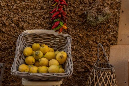 Lemons in a wicker basket, decorating a catering stand on the island of Mallorca. Image of the healthy Mediterranean dietの写真素材