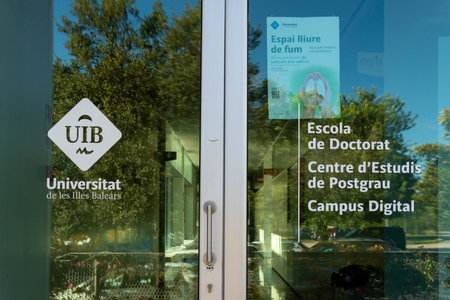 Palma de Mallorca, Spain; december 15 2022: Logo of the University of the Balearic Islands, Uib, stamped on an exterior window pane on a sunny morning. Island of Majorca, Spainのeditorial素材