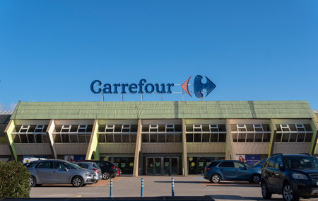 Sa Coma, Spain; February 17 2023: Main facade of the multinational hypermarket company Carrefour, in the Majorcan town of Sa Coma, Spainのeditorial素材