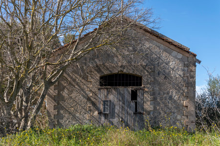 Santanyi, Spain; March 26 2023: Building in the middle of the countryside in a state of ruin and abandonment. Problem of the abandonment of the rural world in Spain. Santanyi, island of Majorcaのeditorial素材