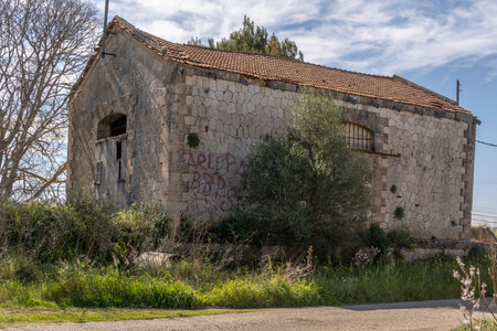Santanyi, Spain; March 26 2023: Building in the middle of the countryside in a state of ruin and abandonment. Problem of the abandonment of the rural world in Spain. Santanyi, island of Majorcaのeditorial素材