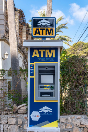 Portocolom, Spain; April 23 2023: ATM of the multinational company Euronet, on the street in the Majorcan town of Portocolom, Spainのeditorial素材