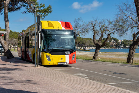 Portocolom, Spain; April 23 2023: Bus of the public company TIB, transport of the Balearic Islands, at a stop in the Majorcan town of Portocolom, Spainのeditorial素材