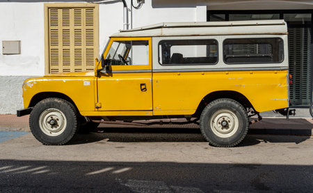 Portocolom, Spain; April 23 2023: Land Rover Santana yellow SUV, parked in the Majorcan town of...