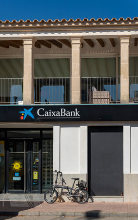 Portocolom, Spain; April 23 2023: Bank office of the Spanish bank Caixabank, in the Majorcan town of Portocolom, Spainのeditorial素材