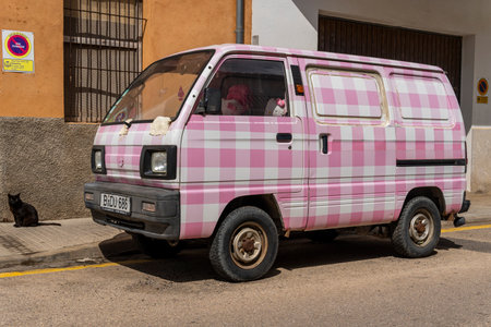Felanitx, Spain; June 18 2023: Suzuki Carry small van with pink and white print parked on the street. Felanitx, island of Majorca, Spainのeditorial素材
