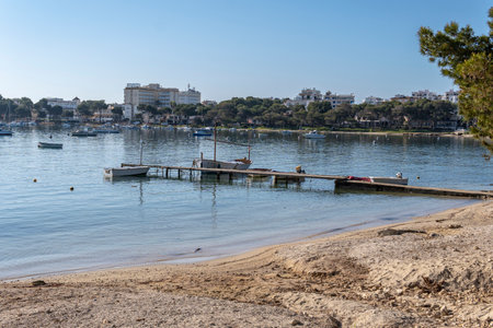 General view of Portocolom beach with a traditional boat jetty at sunrise. Island of Majorca, Spainのeditorial素材