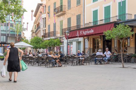 Manacor, Spain; July 21 2023: Terrace of the famous cafeteria Center Cultural S'Agricola with customers. Manacor, island of Majorca, Spainのeditorial素材